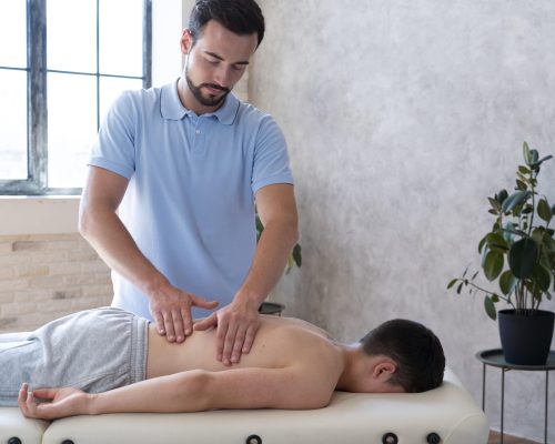 medium-shot-physiotherapist-massaging-back